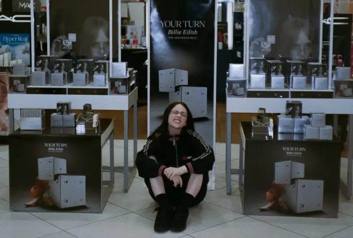 Billie Eilish posing with new perfume